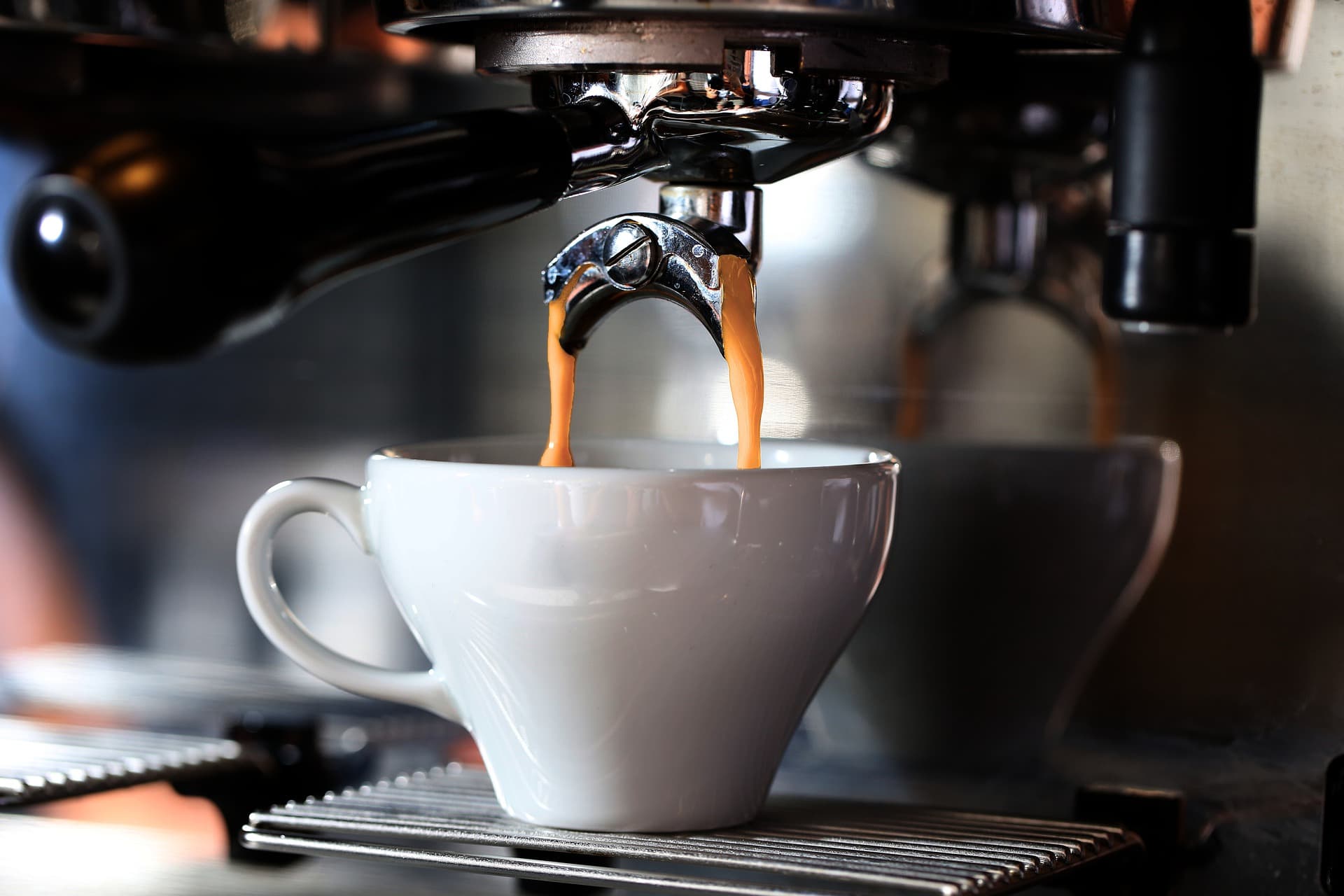 Coffee poured into mug from machine